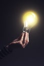 Shining light bulb in female hand Royalty Free Stock Photo