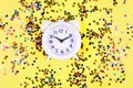 Shining little colorful stars with alarm clock on yellow background Royalty Free Stock Photo