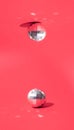 Shining silver disco balls on the floor and ceiling. Minimal New Year\'s in Christmas design on a red background Royalty Free Stock Photo