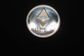 shining silver ether coin from cryptocurrency top middle on black