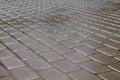 Shining wet rectangular tiled stone pavement