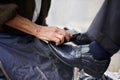 Shining your shoes. a shoe shiner shining a businessmans shoes. Royalty Free Stock Photo