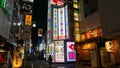 A Shinjuku side street at night, with colorful sign for a Robot Restaurant, and neon light billboard, Tokyo, Japan
