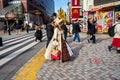 Shinjuku, Tokyo, Japan - December 26, 2018: Beautiful girl with crossplay suit waling in the crowd pedestrians people. Famous