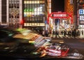 View of cityscape at night with colorful advertisement billboard light beside the street