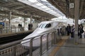 Shinkansen or bullet train arriving on a boarding platform at Shin-Osaka station Royalty Free Stock Photo