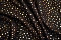 shinning gold dots on a black satin fabric