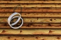 2 Shinny Silver Rings on bamboo plank.