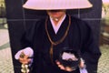 Shinto Monk Ringing Donation Bell in Tokyo Royalty Free Stock Photo