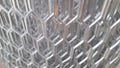 shiny aluminium mesh roll in a factory with partially blurred