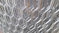 shiny aluminium mesh roll in a factory with partially blurred Royalty Free Stock Photo
