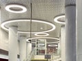 Shiny beautiful shining expensive white high-tech futuristic ceiling with round neon lamps