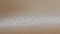 Shiny beige leather background close-up. Beige Glossy Texture Of Artificial Leather. Royalty Free Stock Photo