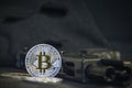 Shiny Bitcoin coin with gun and black mask