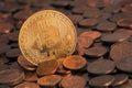 Shiny Bitcoin sticking out from pile of old euro cent coins