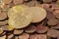 Shiny Bitcoins laying on a pile of used copper coins