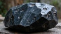 Shiny black obsidian boulder with rainbow streaks sharp edges and iridescent layers Royalty Free Stock Photo
