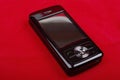 Shiny black PDA on red. Royalty Free Stock Photo