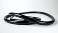 Shiny black rubber Oring lying on white surface Royalty Free Stock Photo