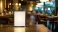 Shiny blank menu standing on wooden table in elegant restaurant with warm lighting Royalty Free Stock Photo
