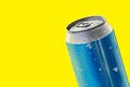 Shiny blue aluminium can over a yellow background.
