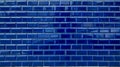 Shiny blue brick tiles background texture on exterior wall