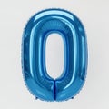 Shiny blue foil balloon number zero on a light background Royalty Free Stock Photo