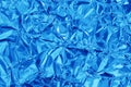 Shiny blue foil texture background, pattern of wrapping paper with crumpled and wavy Royalty Free Stock Photo