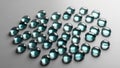 Shiny blue green glass pebbles scattered on a smooth grey surface Royalty Free Stock Photo