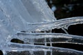 Close up of shiny and blue icicles with a dark background