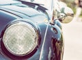 Shiny blue vintage car, detail view of the headlight, photo filter Royalty Free Stock Photo