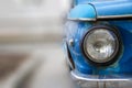 Shiny blue vintage car. Detail view of the headlight. Retro car. Front light. Retro automobile scene. Circle headlamp