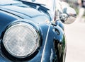 Shiny blue vintage car, detail view of the headlight Royalty Free Stock Photo