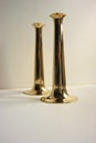 Shiny brass candle holders in mid century design