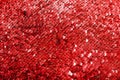 Shiny bright texture of red sequins. Fabric for fancy dresses. Royalty Free Stock Photo