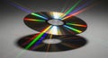 Shiny cd with rainbow light reflections and shadow on a textured surface Royalty Free Stock Photo