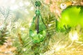 Shiny Christmas green crystal hanging on pine branches with festive background