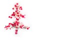 Shiny Christmas tree isolate. Figure of a Christmas tree on a white background of shiny multi-colored confetti. Happy new year and Royalty Free Stock Photo