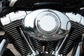 Shiny chrome motorcycle parts close-up. A large tourist motorbike. Engine cylinders and cooling fins close-up Royalty Free Stock Photo