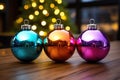 shiny colored Christmas ball bouncing in front of blurred Christmas candle light and unfocused bokeh Royalty Free Stock Photo