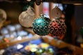 Shiny colorful glass Christmas balls in cardboard boxes on shelves. Christmas market of retro style decorations. Christmas fair Royalty Free Stock Photo