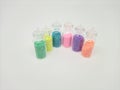 shiny colorful knick-knacks in clear, transparent bottles