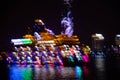 Blurry neon lights of night cityscape and ship at river in Shanghai China. Intentional motion blur Royalty Free Stock Photo