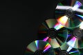 Shiny compact discs on black background, top view. Space for text Royalty Free Stock Photo