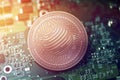 Shiny copper FACTOM cryptocurrency coin on blurry motherboard background