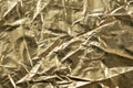 Shiny crumpled gold foil texture background. Pattern of golden wrapping textile crumpled and wavy. Copy space. Celebration concept Royalty Free Stock Photo