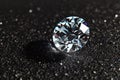 Shiny diamond close-up on black background, luxury brilliant on dark table. Theme of jewel, jewelry, gem, white gemstone, stone, Royalty Free Stock Photo