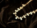 Shiny diamond necklace on black satin background for valentines day. Royalty Free Stock Photo