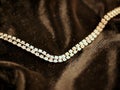 Shiny diamond necklace on black satin background for valentines day. Royalty Free Stock Photo