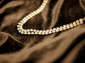 Shiny diamond jewelry necklace on black satin background for valentines day. Royalty Free Stock Photo